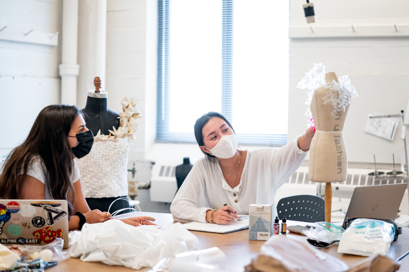 Students working with a design form for an experimental fashion design course