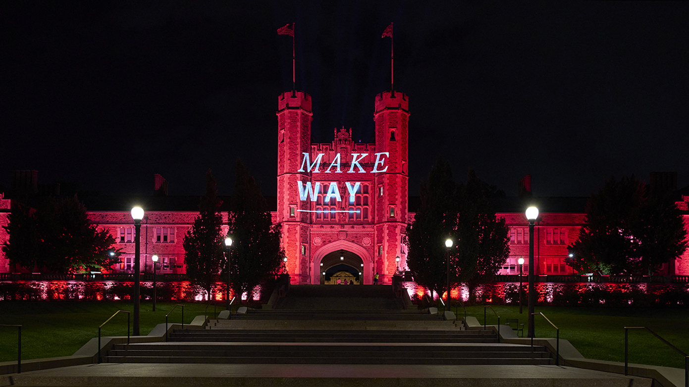 Brookings Hall lit up in red lights