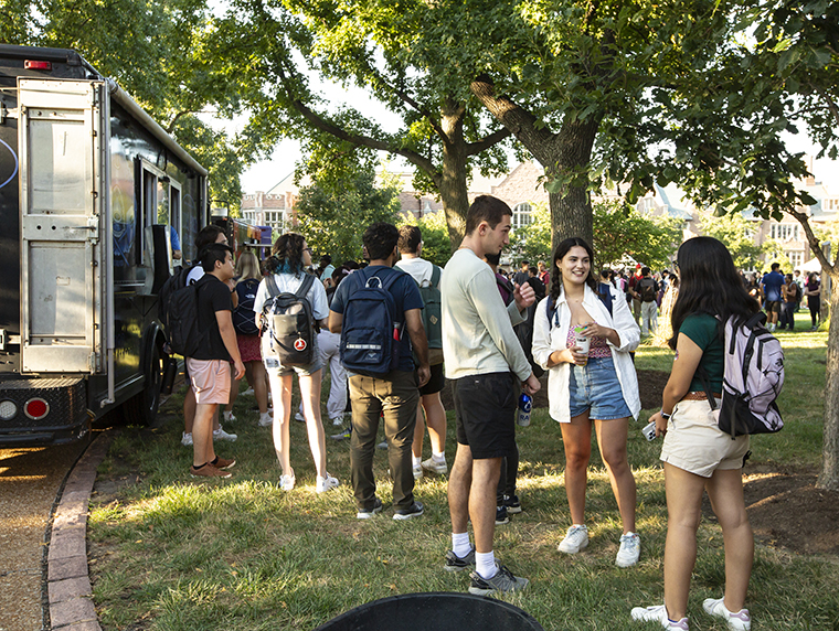 Students line up for food trucks at Arts & Sciences festival