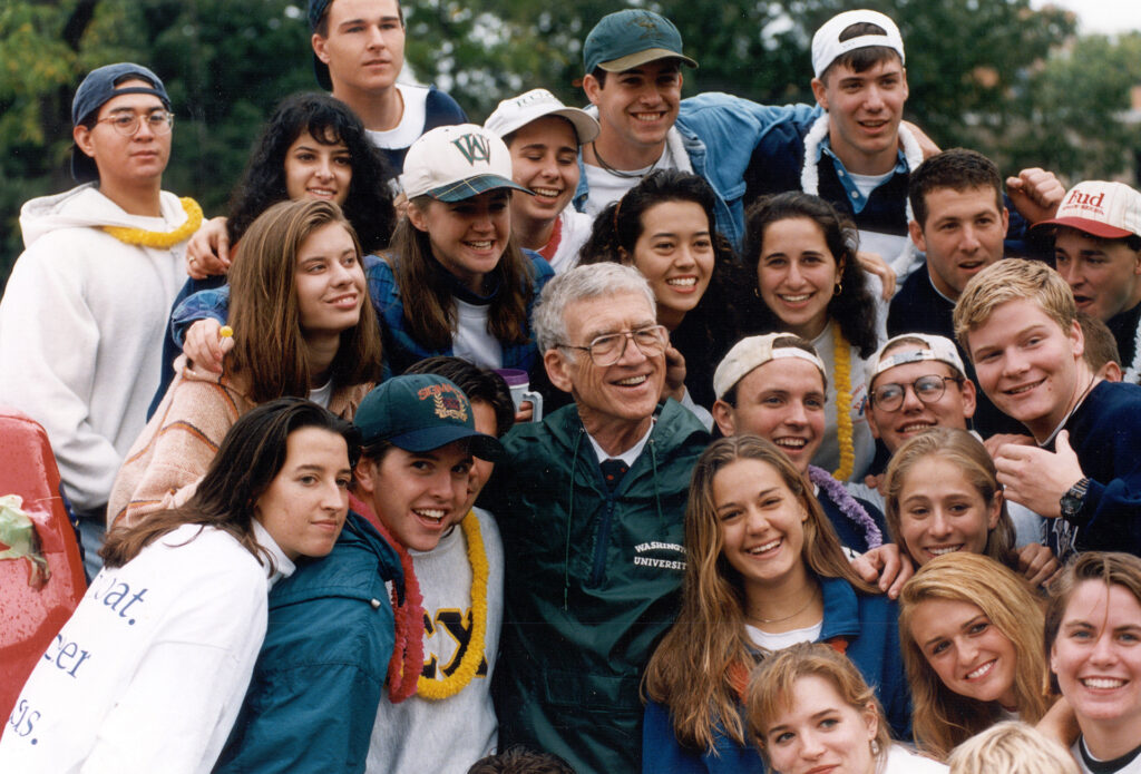 Chancellor Danforth surrounded by students during homecoming in 1994.